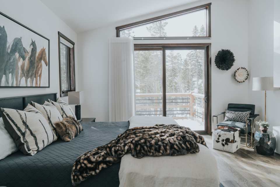 cozy layers in ski chalet bedroom with artwork above bed 